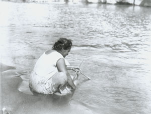 Hawaiian woman fishing for Hinana, Kauai circa 1912